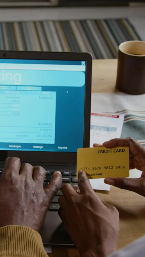 African American Man using Banking Website and Holding Credit Card Vertical Stock Footage 327684921