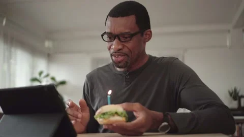 African American man using laptop for video call celebrating online birthday Stock Footage 138943301