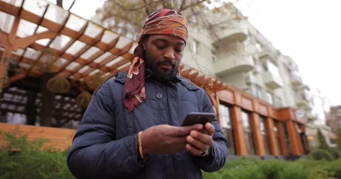 African American man using mobile phone in the city street Stock Footage 145531334