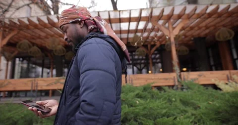 African American man using mobile phone in the city street Stock Footage 145531383