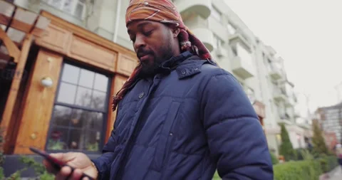 African American man using mobile phone in the city street Stock Footage 145531609