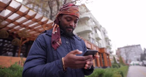 African American man using mobile phone in the city street Stock Footage 145768563