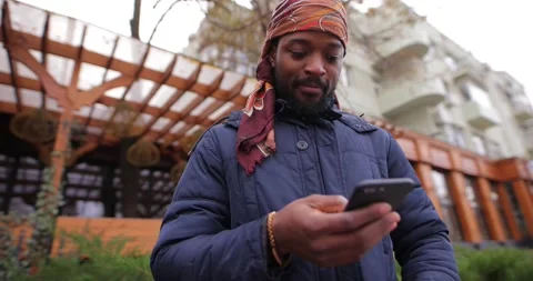 African American man using mobile phone in the city street Stock Footage 145768617