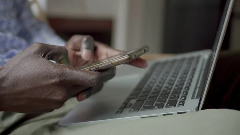 African american man using smartphone and laptop Video stock 100349750