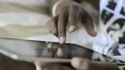 African American man using tablet computer for information. Stockbeeldmateriaal 199628745
