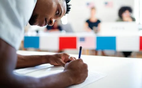 African-american man voter in polling place, usa elections concept. Stock Photos