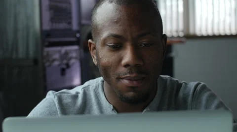 African American man working on a laptop at work, happy Stock Footage