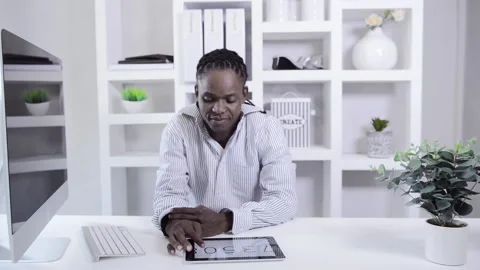African american man working with tablet computer in home office 스톡 동영상 199629687