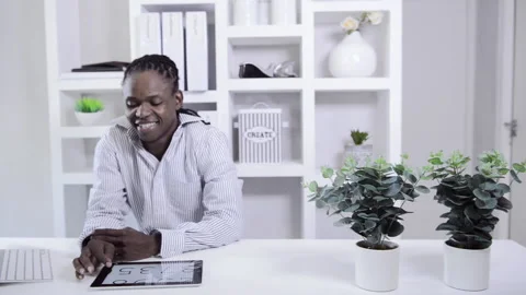 African american man working with tablet computer in home office Stock Footage 199629688