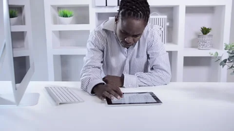 African american man working with tablet computer in home office Vídeo Stock 199629698
