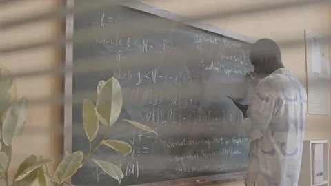 African American Man Writing Computer Code on Chalkboard Stock Footage 257064464