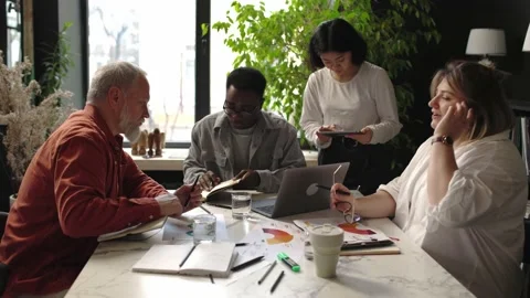 African-American manager discussing development strategy with diverse colleagues Stock Footage 166059224