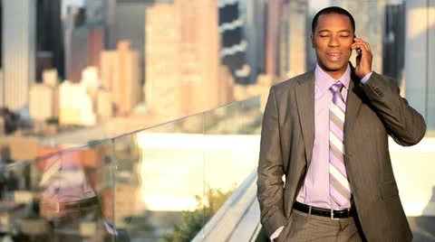 African American manager using mobile on rooftop Manhattan business office  Stock Footage