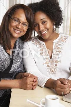 African American Mother And Daughter Hugging