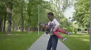 African American Mother Is Spinning Her Son In Her Arms. Mom And Child Spend The Stock Footage