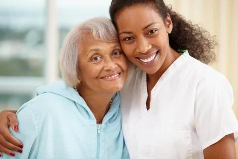 African american nurse hugging senior woman Stock Photos