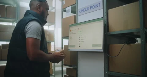 African American Parcel Processing Specialist Checks Package Delivery Stock Footage 307662995