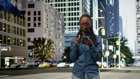 African american person checking map directions on smartphone and walking Stock Footage 334168440