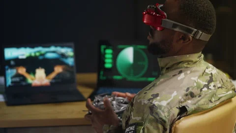 African American pilot practices tactical FPV drone control in command center Stock Footage 346640080