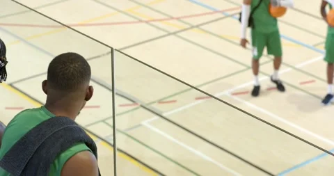 African american player on viewing platform pointing to greet team entering Video stock 335568547
