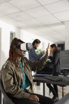African American Programmer interacting with 3D interface using VR glasses Stock Photos