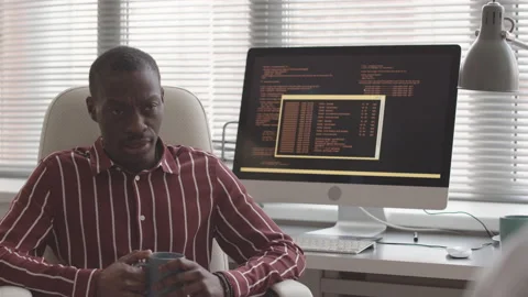 African American Programmer Talking to Colleague in Office Stock Footage 172193475