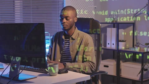 African-American Programmer Typing on Computer at Night Stock Footage 165723983