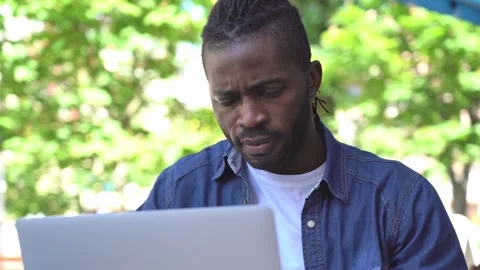 African American programmer using laptop computer, working online outdoors Stock-Footage 157009413