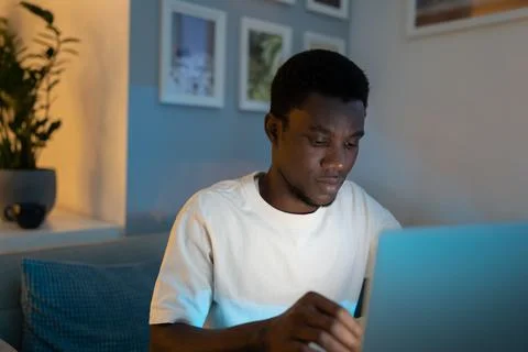 African American programmer writes code for website looking at screen of Stock Photos