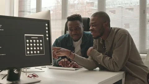 African-American Programmers Discussing Program on PC Stock Footage 165720853