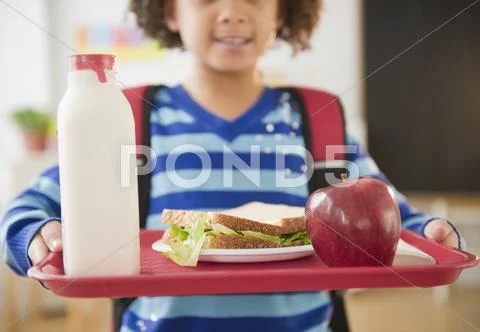 African american school girl holding lunch on a tray Stock Photos