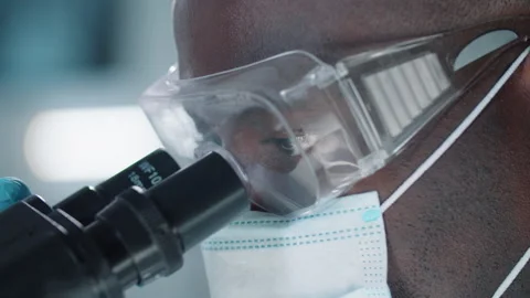 African American Scientist Using Microscope Stock Footage 139679085