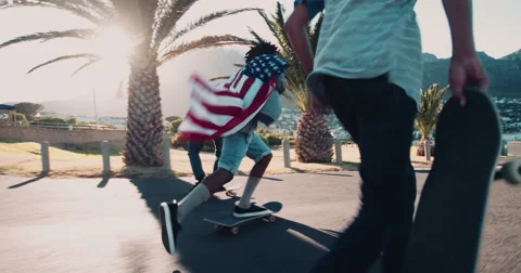 African American Skater Doing Ollie while Holding American Flag Stock Footage