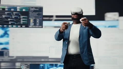 African american software developer uses virtual reality headset for coding Stock Footage 312359593