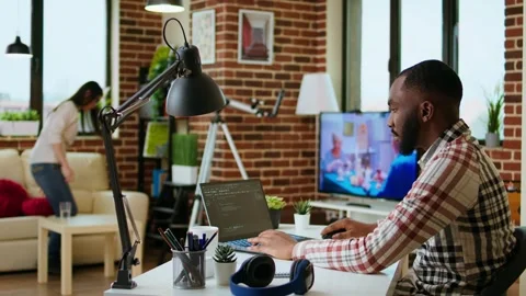 African american software developer works on programming code on a laptop Stock Footage 319719084
