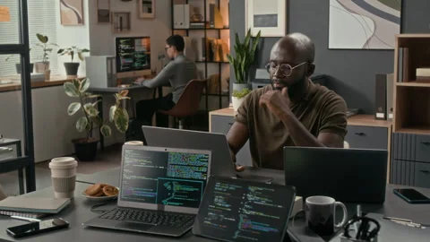 African American Software Engineer Typing on Laptop during Workday in Office Stock Footage 329611597