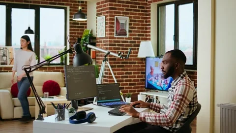 African american software engineer works on laptop typing code for a project Stock Footage 319710646