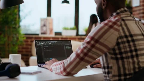 African american software engineer works on laptop typing code for a project Stock Footage 319722590