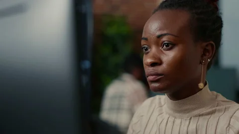 African american software programer working focused looking at computer screen Stock Footage 168252020