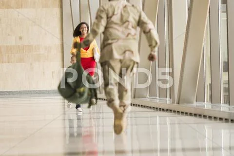 African American Soldier Greeting Wife In Airport