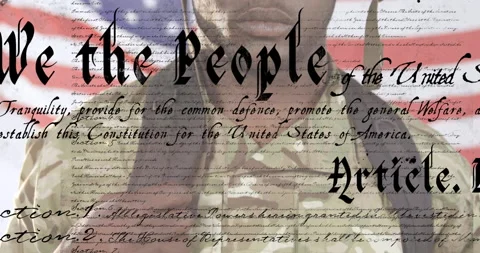 African American soldier with US flag waving and constitution foreground Stock Footage