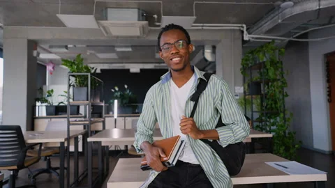 African American student with backpack in classroom Video stock 309481998