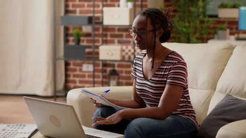 African american student taking notes at online class lesson Stock Footage 203854741