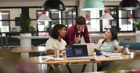 African American study group colleague with headset leaning over laptop Stock Footage 344340474