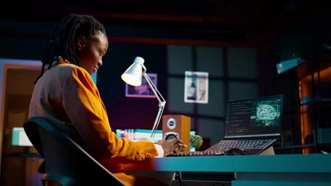 African american system engineer using AI system to write computer program code Stock Footage 265192102