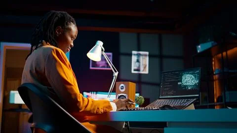 African american system engineer using AI system to write computer program code Stock-Fotos