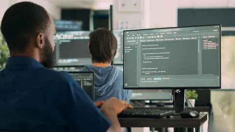 African american system engineer working on software development with source Photos