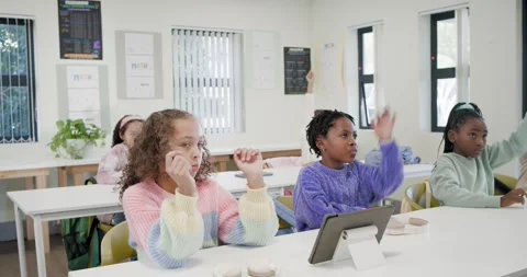 African American teacher asking in class, female child students raising hands to Stock Footage 340674338