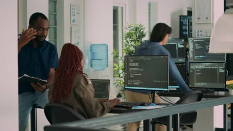 African american team of cloud programers talking about programming compiling Stock Footage 231448689