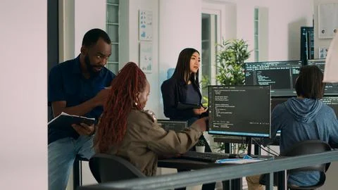 African american team of cloud programers talking about programming compiling 写真素材